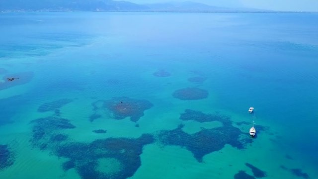Aerial view video from famous organised beach in small island of Monolia part of archipelago paradise exotic islands of Lihadonisia with clear turquoise sea beaches, North Evoia island, Greece
