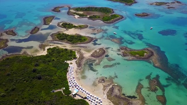 Aerial view video from famous organised beach in small island of Monolia part of archipelago paradise exotic islands of Lihadonisia with clear turquoise sea beaches, North Evoia island, Greece