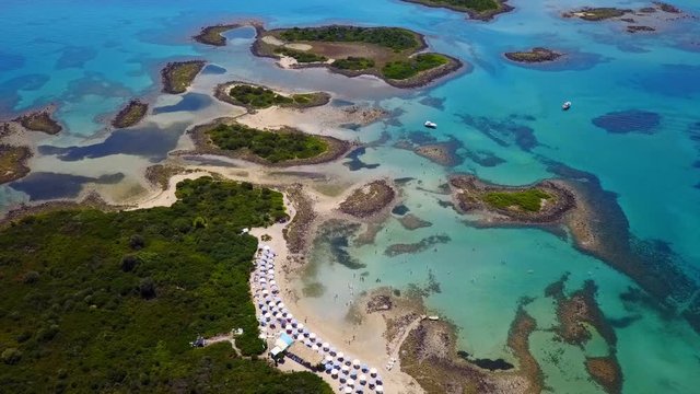Aerial view video from famous organised beach in small island of Monolia part of archipelago paradise exotic islands of Lihadonisia with clear turquoise sea beaches, North Evoia island, Greece