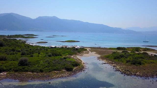 Aerial view video from famous organised beach in small island of Monolia part of archipelago paradise exotic islands of Lihadonisia with clear turquoise sea beaches, North Evoia island, Greece