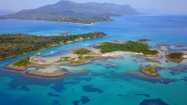 Aerial view video from famous organised beach in small island of Monolia part of archipelago paradise exotic islands of Lihadonisia with clear turquoise sea beaches, North Evoia island, Greece