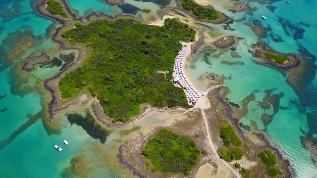 Aerial view video from famous organised beach in small island of Monolia part of archipelago paradise exotic islands of Lihadonisia with clear turquoise sea beaches, North Evoia island, Greece