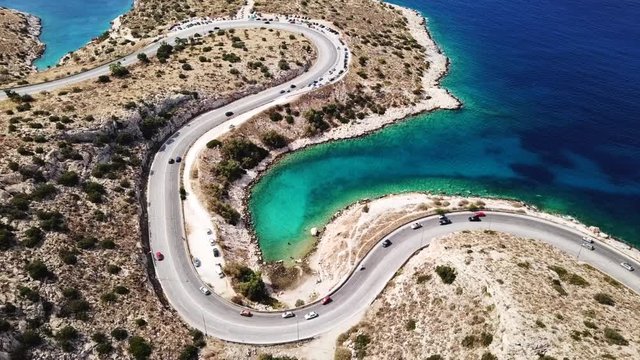 Aerial drone bird's eye view video of Tunel in Athens riviera seaside road known as hole of Karamanlis, Attica, Greece