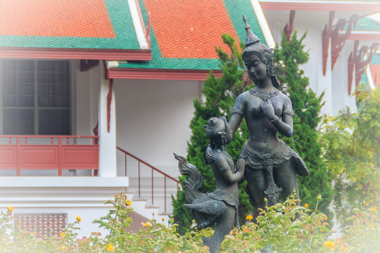 Cute bronze mother and son kinnaree sculptures in the green garden at Bhubing palace, Chiang Mai, Thailand. Kinnari or kinnaree is depicted as woman wearing an angel-like costume and similar to a bird