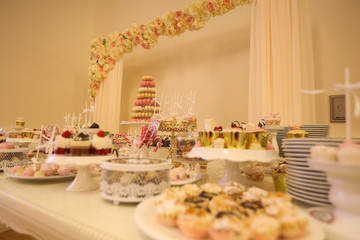Delicious candy bar with macarons, cupcakes, cake pop and other sweets