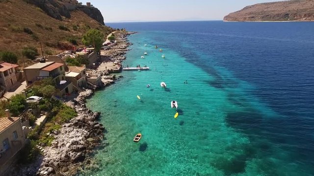 Aerial birds eye view video taken by drone of famous picturesque village of Limeni with turquoise clear waters, Peloponnese, Greece