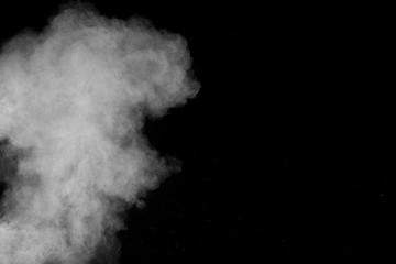 Bizarre forms of white powder explosion cloud against black background.White dust particles splash.