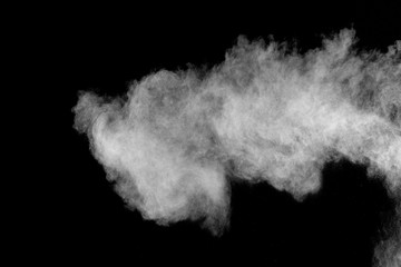 Bizarre forms of white powder explosion cloud against black background.White dust particles splash.