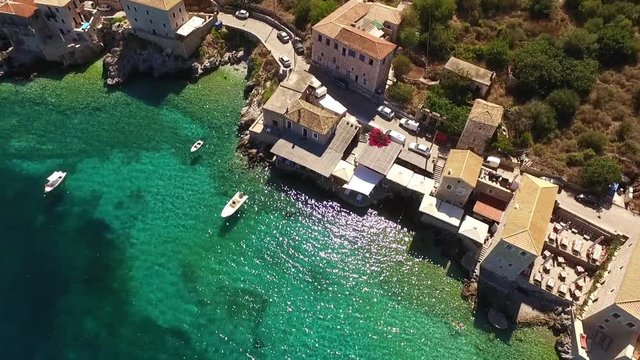 Aerial birds eye view video taken by drone of famous picturesque village of Limeni with turquoise clear waters, Peloponnese, Greece