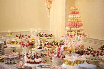 Delicious candy bar with macarons, cupcakes, cake pop and other sweets