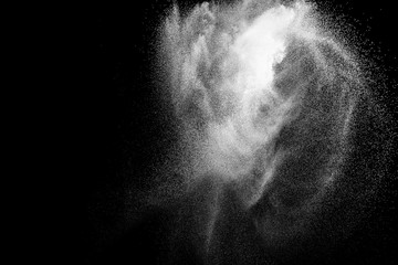 Bizarre forms of white powder explosion cloud against black background.White dust particles splash.