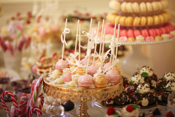 Delicious candy bar with macarons, cupcakes, cake pop and other sweets