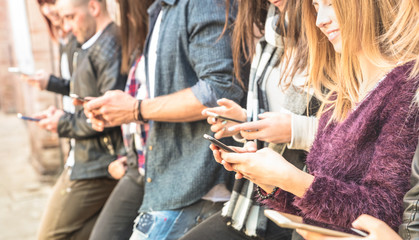 Group of multicultural friends using smartphone at university college backyard break - People hands...