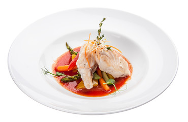 Smoked mackerel with vegetables and sauce. On white background