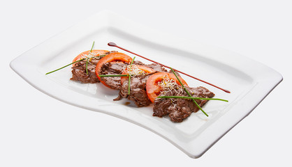 Beaten fried veal with tomatoes on white background