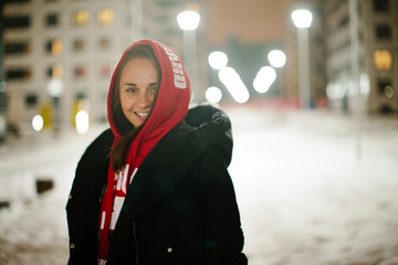 Brunette girl posing at the night winter street