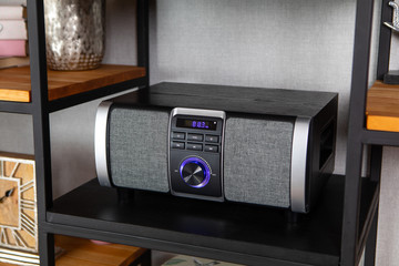 Compact CD radio player on the shelf in the vintage interior of the living room