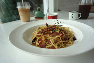 Thai style Dried Chili and Bacon Spaghetti  serving on white plate