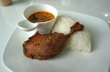 Deep fried duck leg with Thai style red curry serving with white rice