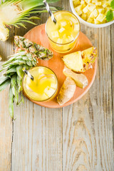 Healthy and immunity diet drink. Ginger and pineapple cold tea, infused water, Wooden background copy space