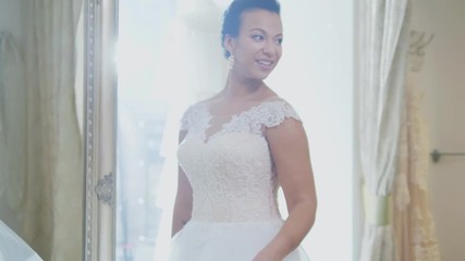 Beautifu bride choosing wedding dress in a wedding salon