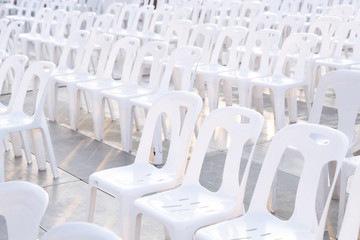 White plastic chairs in rows celebration and outdoor event.