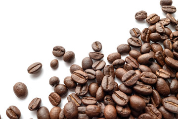 Roasted coffee beans isolated on white background. Close-up.