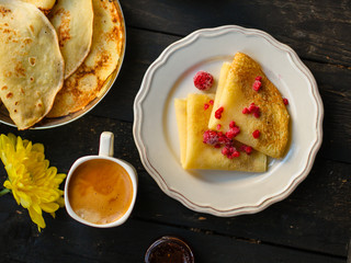 pancakes crepes fritters with raspberry berries (pancakes with filling) Shrovetide. food background. top view