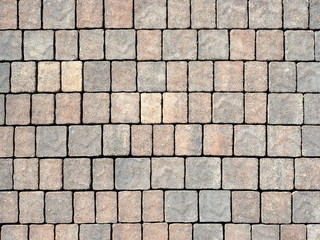 Fragment of masonry gray and beige shades close-up in daylight.