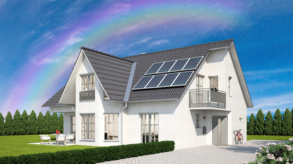 Solaranlage auf Dach von Haus vor Regenbogen