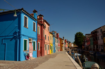Fototapeta na wymiar Colorful concept. Venice, Burano island canal, small colored houses and the boats