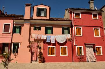 Fototapeta na wymiar Venice, Burano, small colored houses. Colorful concept, orange and blue