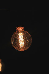 Decoration of the cafeteria. Edison incandescent lamps. Street decor Light lanterns Warm light at night. The web is in the middle of the light bulb. Macro shooting bulbs.