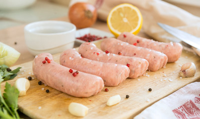 raw pork sausages, sausages on cutting Board, spices,