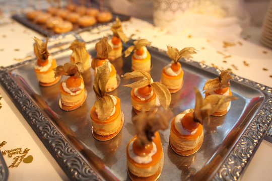 Delicious cankes with passion fruit on silver plate