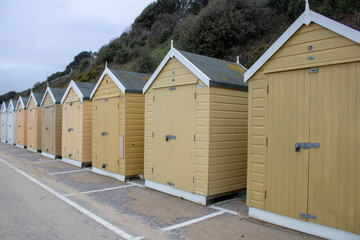 Fototapeta na wymiar Beach huts on the beach in Bournemouth.