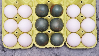 Eggs in box on stone background.