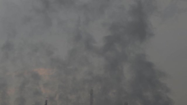 smoke from chimneys of utility plant at Oil Refinery industry . footage video for pollution industry concept .