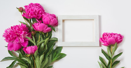 Bouquet of beautiful pink peony flower and white frame for text. Copy space. Top view. Flat lay.