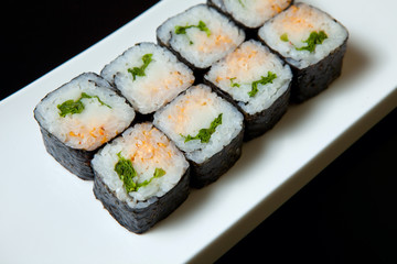 Traditional fresh japanese set sushi rolls on a black background