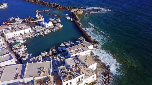 Aerial bird's eye view video taken by drone of iconic and picturesque port of Naousa village, Paros island, Cyclades, Greece