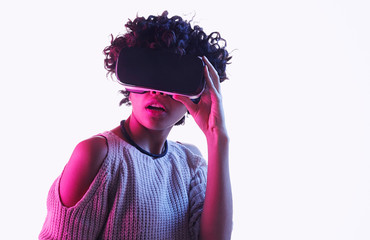 Astonished black teen girl exploring virtual reality