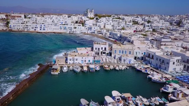 Aerial bird's eye view video taken by drone of iconic and picturesque port of Naousa village, Paros island, Cyclades, Greece