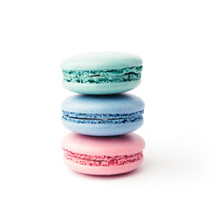 Stack of three colourful french macarons isolated on white background. Pink, blue and turquoise macarons.