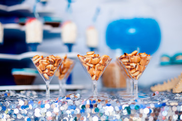 Candy bar for kids party. Snacks, cookies fish shaped on the elegant glasses. Summer season delicious on the party