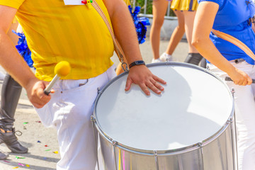 Hands drummer with a beater on the drum.