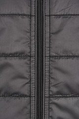 Naklejka premium Close-up of a down jacket grey and zipper
