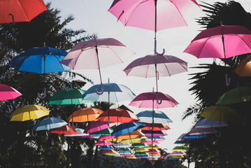 Fototapeta na wymiar Lots of umbrellas coloring the sky