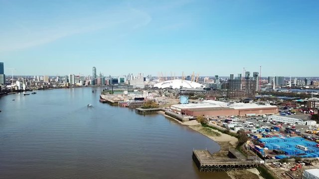 Aerial drone bird's eye view video cruising in river Thames near iconic concert Hall of O2 Arena, London, United Kingdom