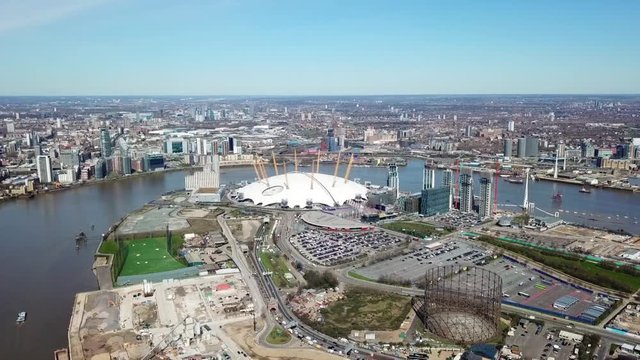 Aerial drone bird's eye view video cruising in river Thames near iconic concert Hall of O2 Arena, London, United Kingdom